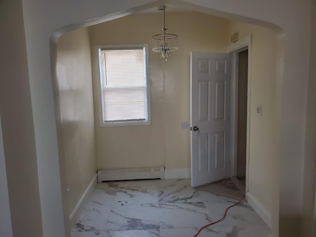 interior space with baseboard heating and a notable chandelier