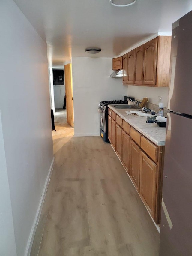 kitchen with refrigerator and stainless steel range with gas stovetop