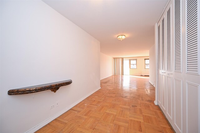 corridor featuring light parquet flooring