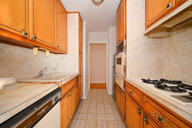 kitchen with white appliances, sink, and tasteful backsplash