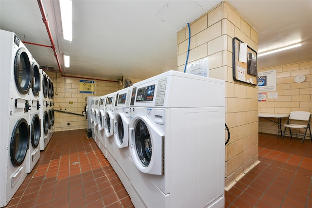 clothes washing area featuring stacked washing maching and dryer and separate washer and dryer