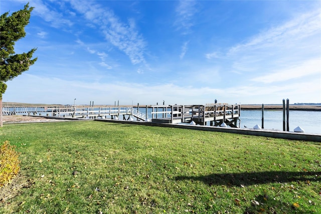 dock area with a yard and a water view