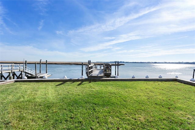 view of dock featuring a yard and a water view