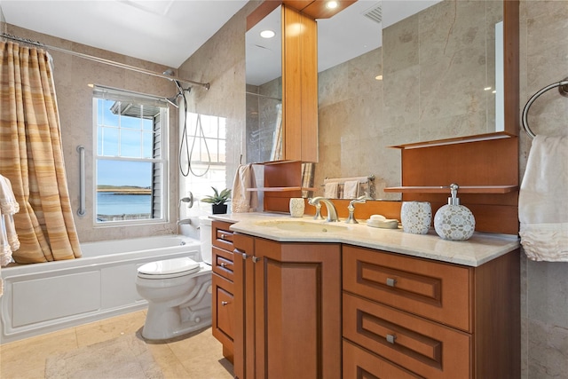 full bathroom featuring vanity, shower / bathtub combination with curtain, tile walls, and toilet