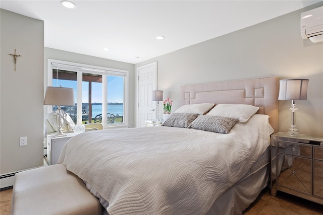 bedroom featuring a water view and a wall unit AC