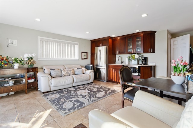 living room featuring light tile patterned floors and sink