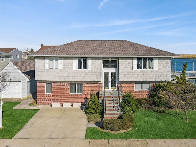 view of front of home featuring a water view and a front lawn