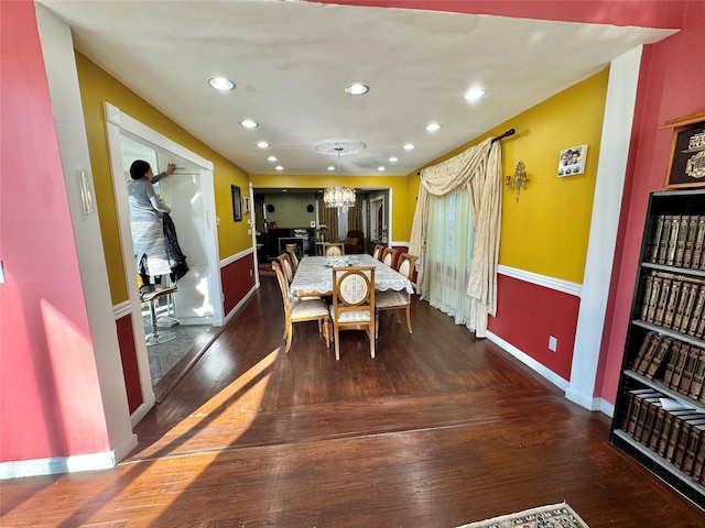 dining area featuring dark hardwood / wood-style flooring and a notable chandelier