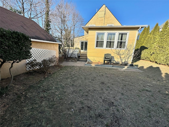 rear view of house featuring a patio area and a lawn