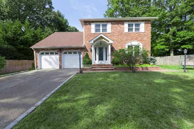 view of front facade featuring a front yard and a garage