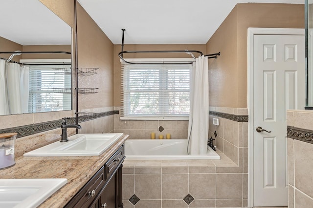 bathroom with shower / bathtub combination with curtain, plenty of natural light, and vanity