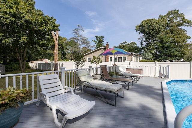 wooden terrace with a fenced in pool