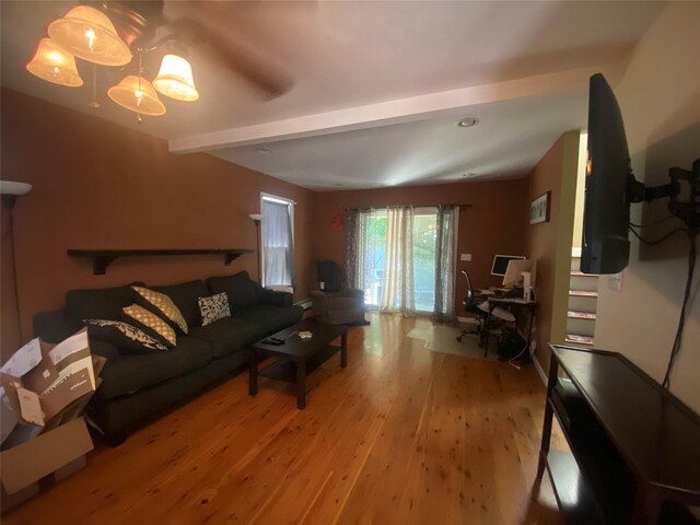 living room with beam ceiling and light hardwood / wood-style floors