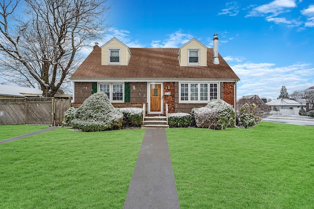 cape cod home with a front yard