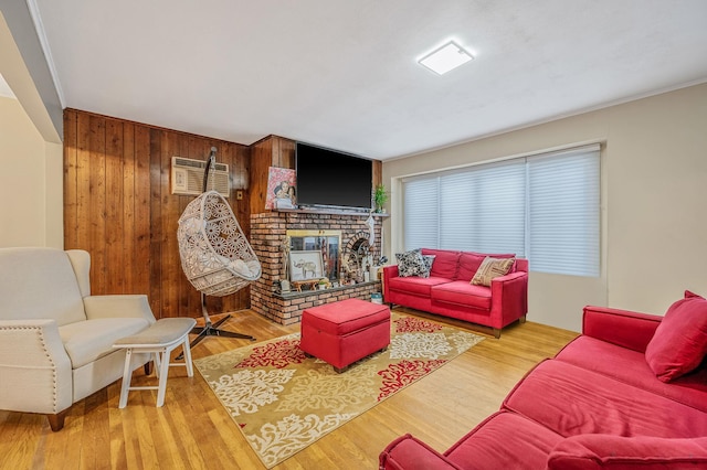 living room featuring hardwood / wood-style flooring, an AC wall unit, and wooden walls