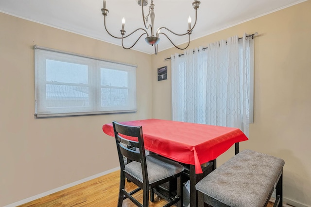 dining space featuring light hardwood / wood-style floors and an inviting chandelier