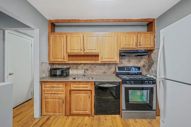 kitchen featuring sink, tasteful backsplash, light stone counters, and black appliances