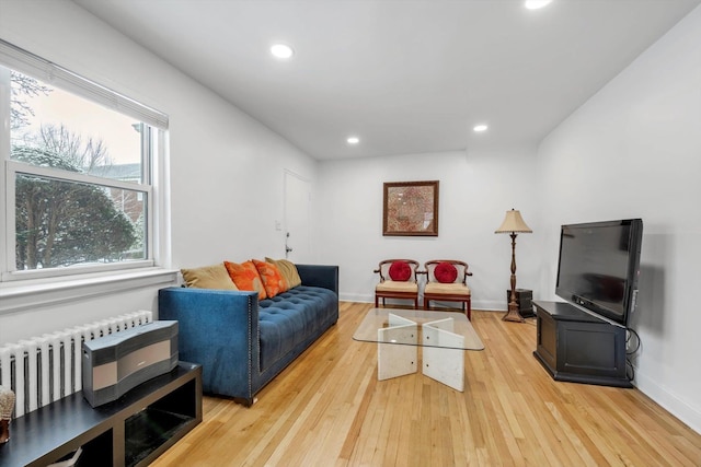 living room with light hardwood / wood-style floors and radiator