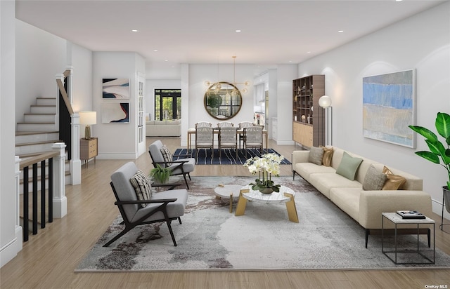 living room featuring a chandelier and light wood-type flooring