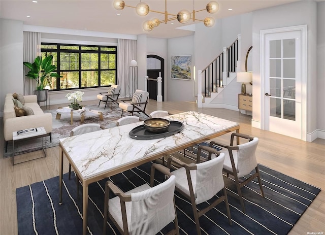 dining space featuring light hardwood / wood-style floors and an inviting chandelier