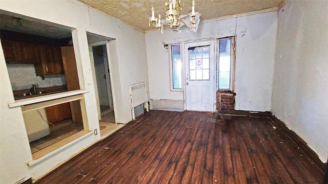 unfurnished dining area with dark hardwood / wood-style floors and an inviting chandelier