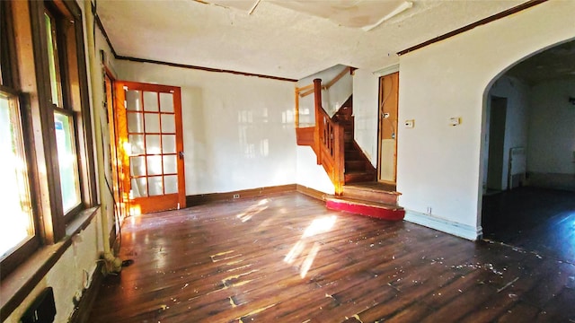 spare room featuring dark hardwood / wood-style floors and ornamental molding