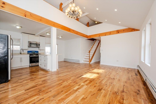 interior space featuring a notable chandelier, light hardwood / wood-style flooring, sink, and a baseboard heating unit