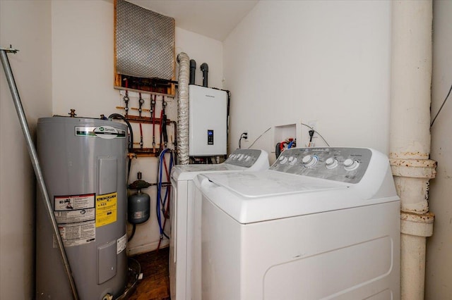 clothes washing area featuring washer and dryer, electric water heater, and water heater