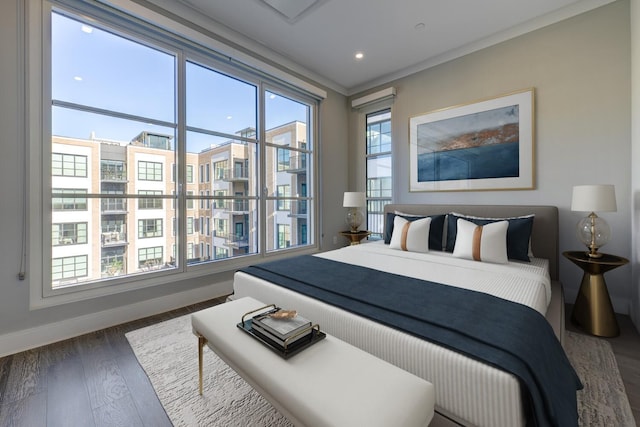 bedroom featuring crown molding and dark hardwood / wood-style flooring