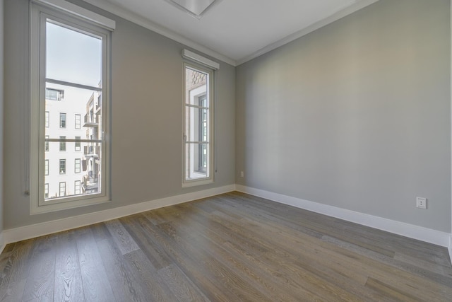 unfurnished room featuring hardwood / wood-style floors and crown molding