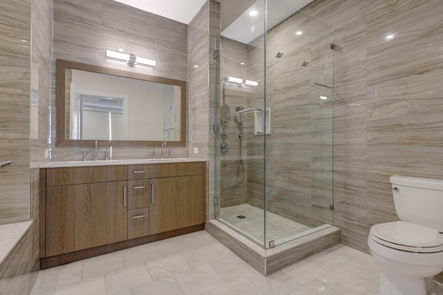 bathroom featuring vanity, toilet, an enclosed shower, and tile walls