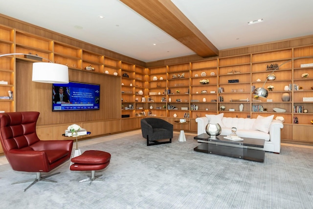 sitting room featuring beamed ceiling, light carpet, and built in features