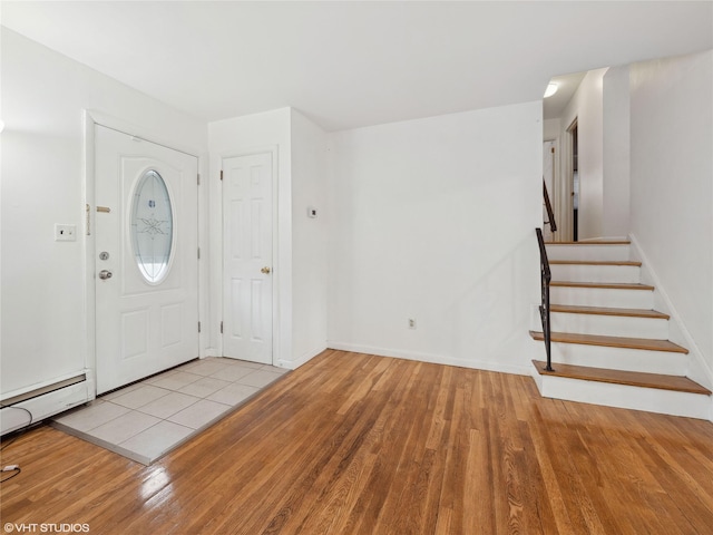 entryway with baseboard heating and light hardwood / wood-style flooring