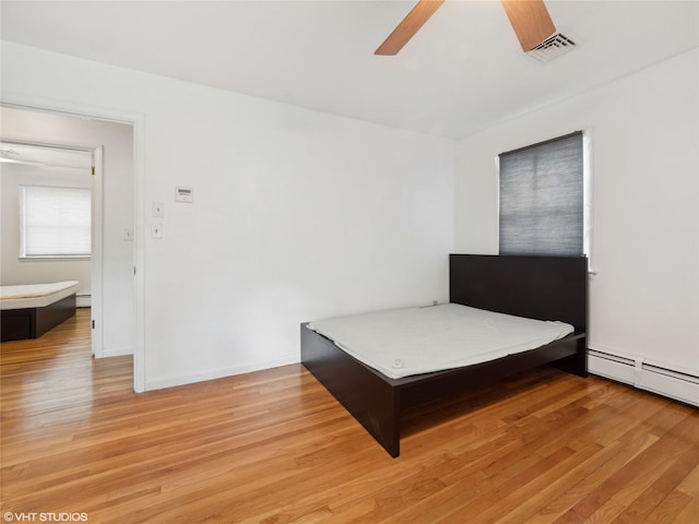 bedroom featuring ceiling fan and hardwood / wood-style flooring