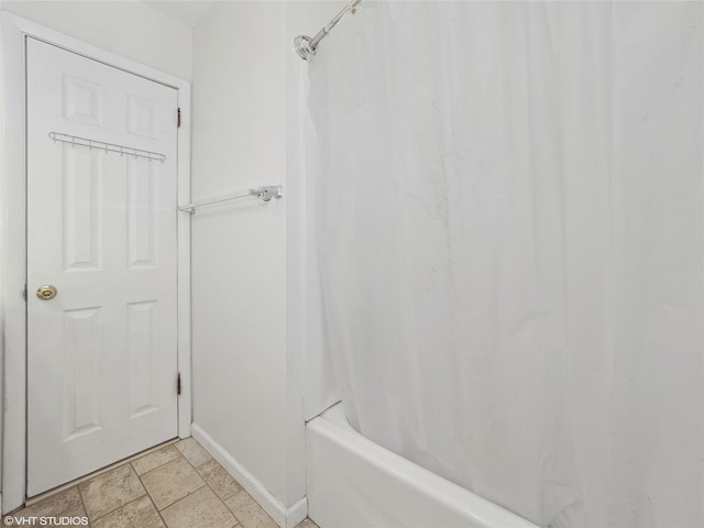 bathroom with shower / bath combination with curtain