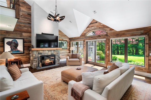 living room featuring wood-type flooring, a wealth of natural light, and a fireplace