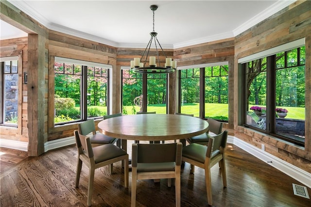 dining space featuring crown molding, dark wood-type flooring, and a wealth of natural light