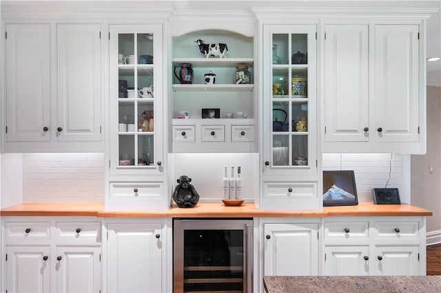 bar with wine cooler, tasteful backsplash, and white cabinets