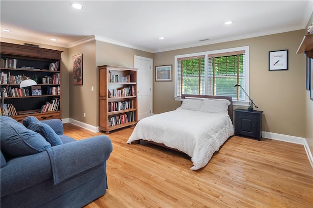 bedroom with ornamental molding and light wood-type flooring