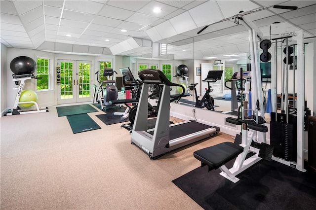 exercise room featuring a drop ceiling, french doors, and carpet