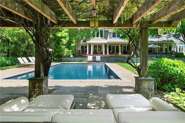 view of pool featuring an outdoor living space and a patio area