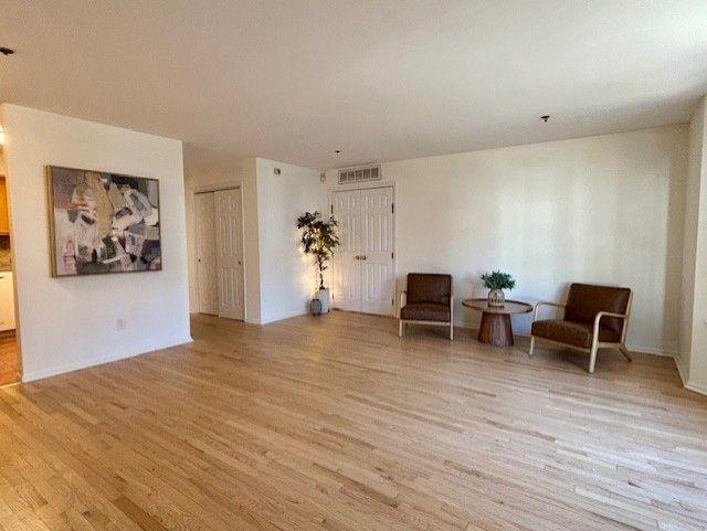 sitting room with light hardwood / wood-style flooring