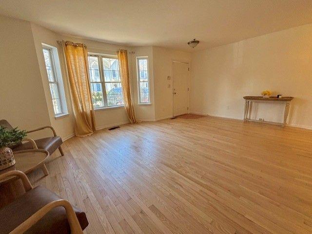 unfurnished living room featuring light wood-type flooring