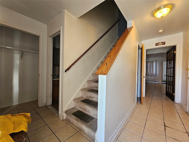 staircase featuring tile patterned floors