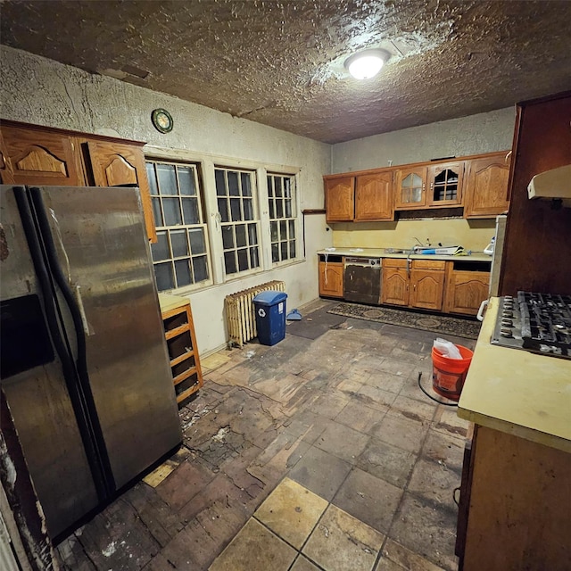 kitchen with gas stovetop, stainless steel refrigerator, dishwasher, and exhaust hood