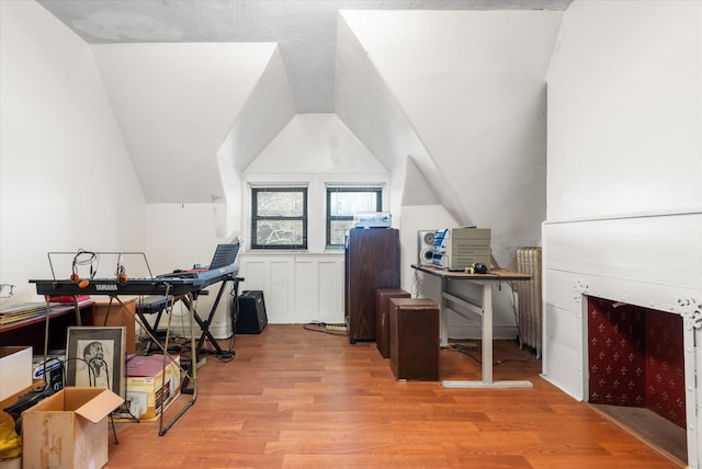 office space with light wood-type flooring and lofted ceiling