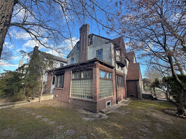 view of side of home featuring a lawn