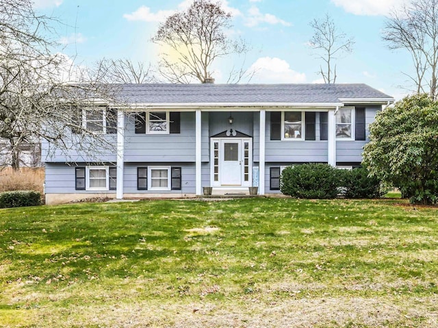 bi-level home with a front lawn