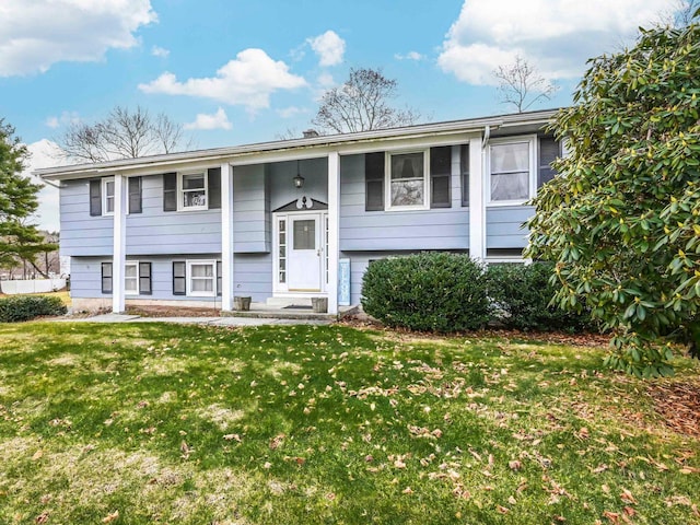 raised ranch featuring a front lawn