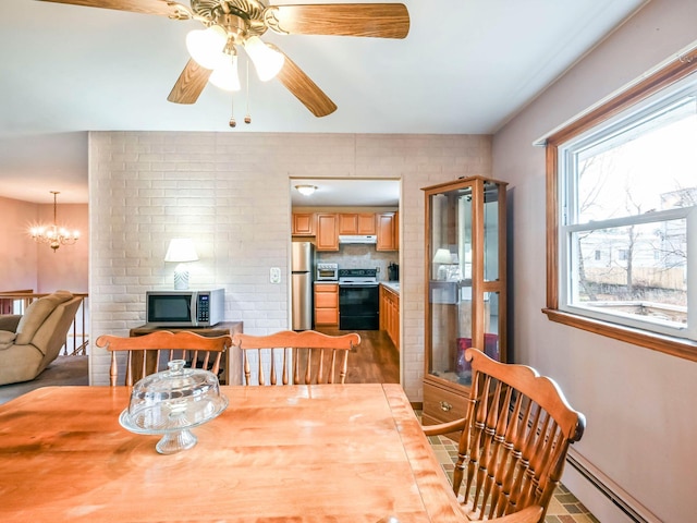 dining area with tile patterned flooring, ceiling fan with notable chandelier, and a baseboard heating unit